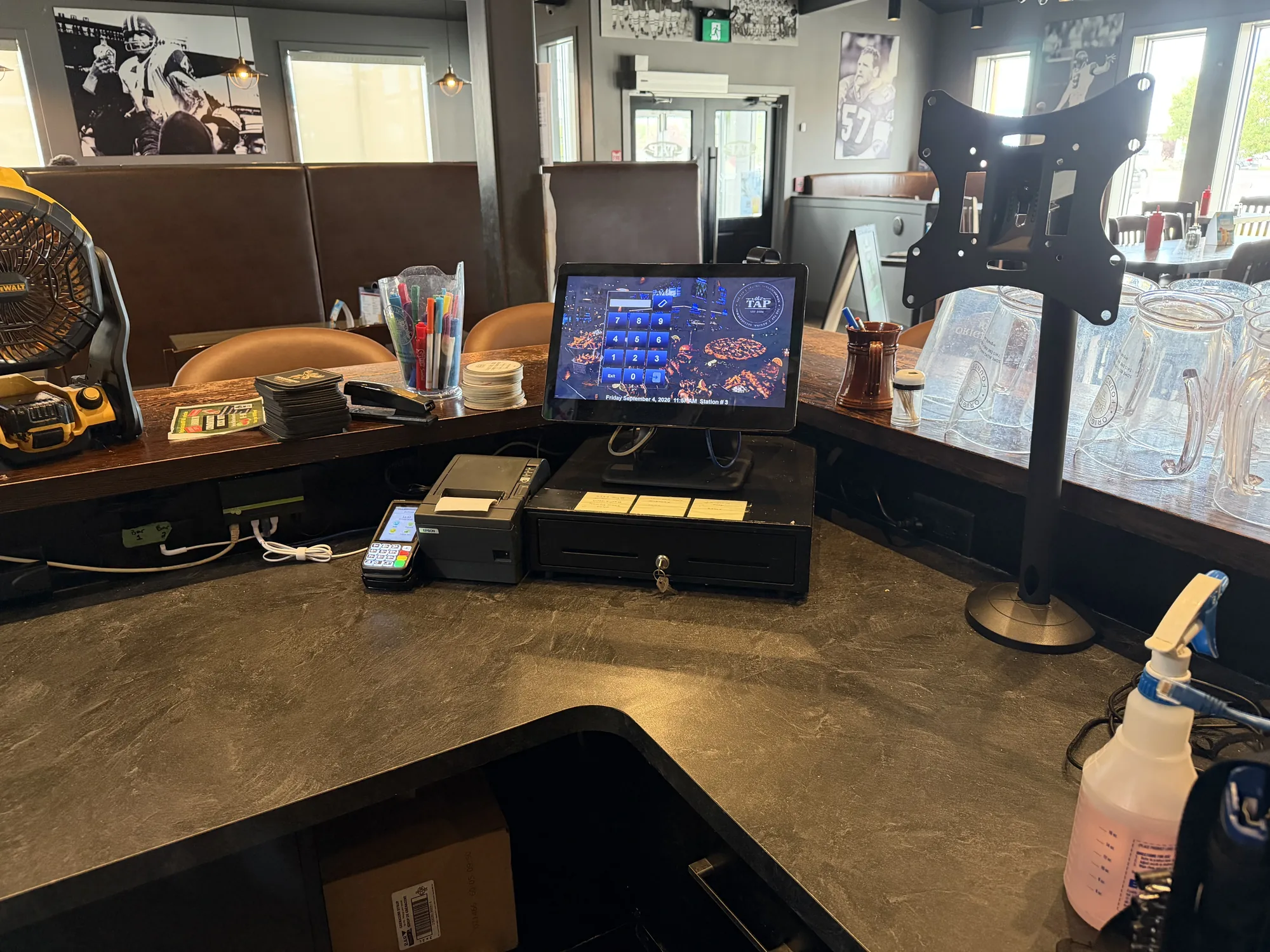 Tidied POS station with terminal, printer, and cash drawer